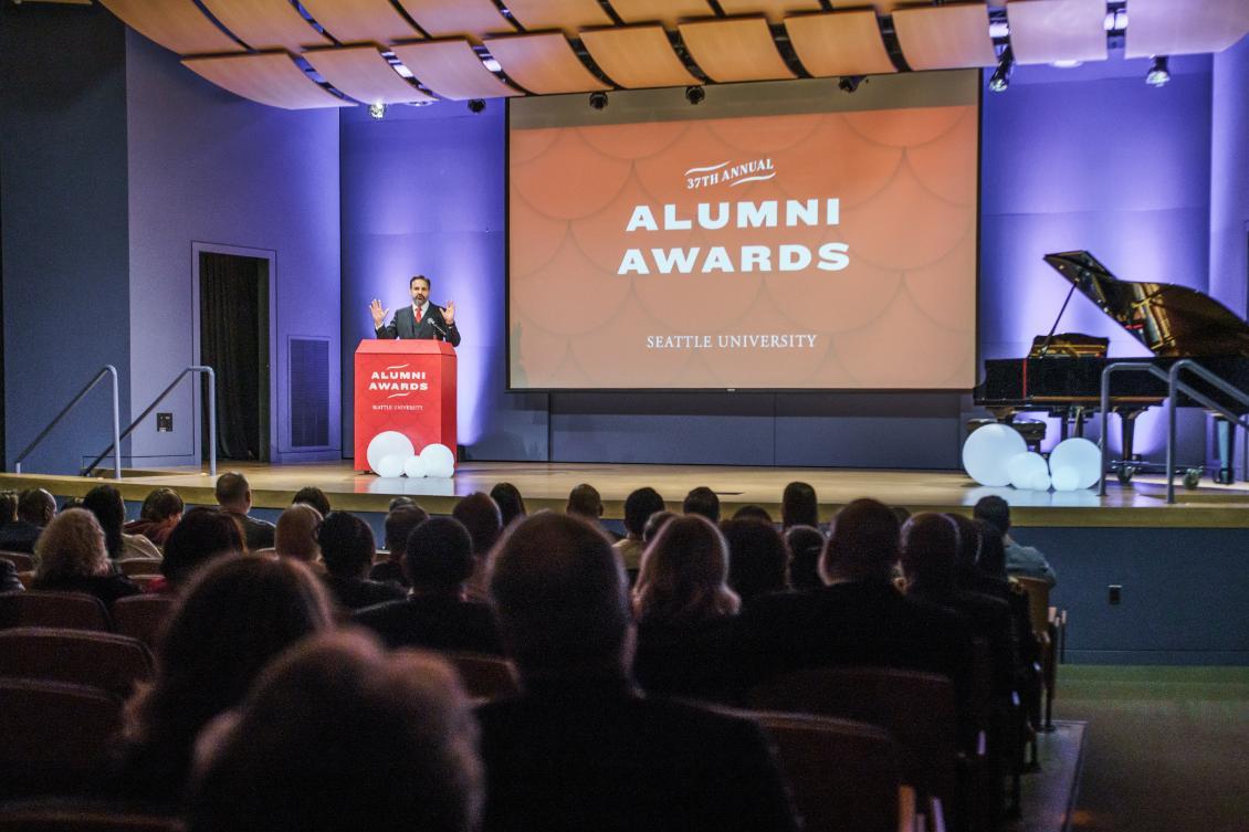 President Peñalver on stage presenting at Alumni Awards