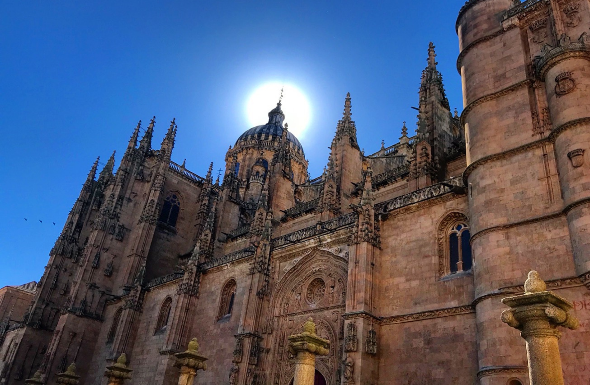 view of a large gothic cathedral with the sun at the top sprier