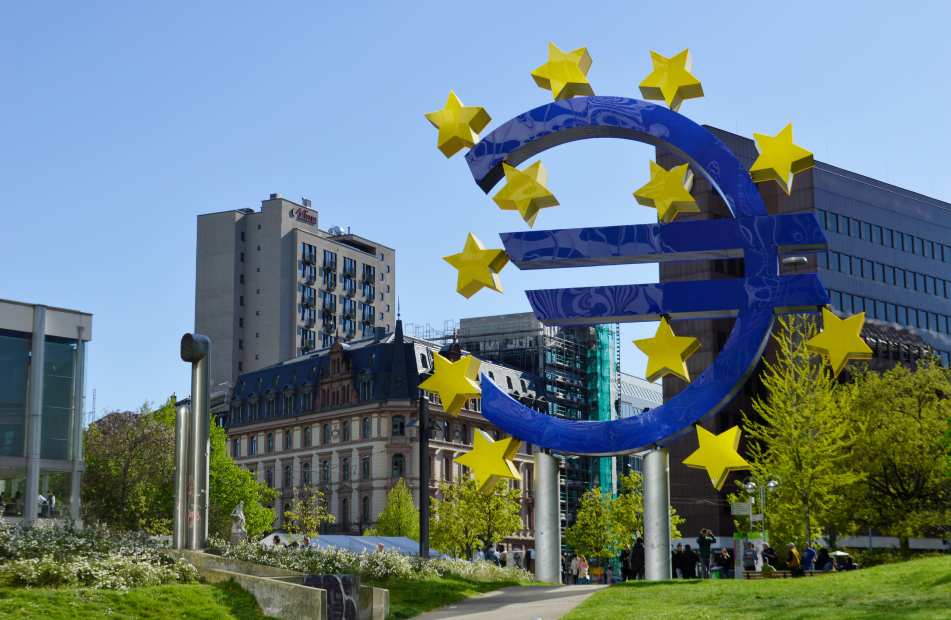 teal skyscraper with Euro logo statue