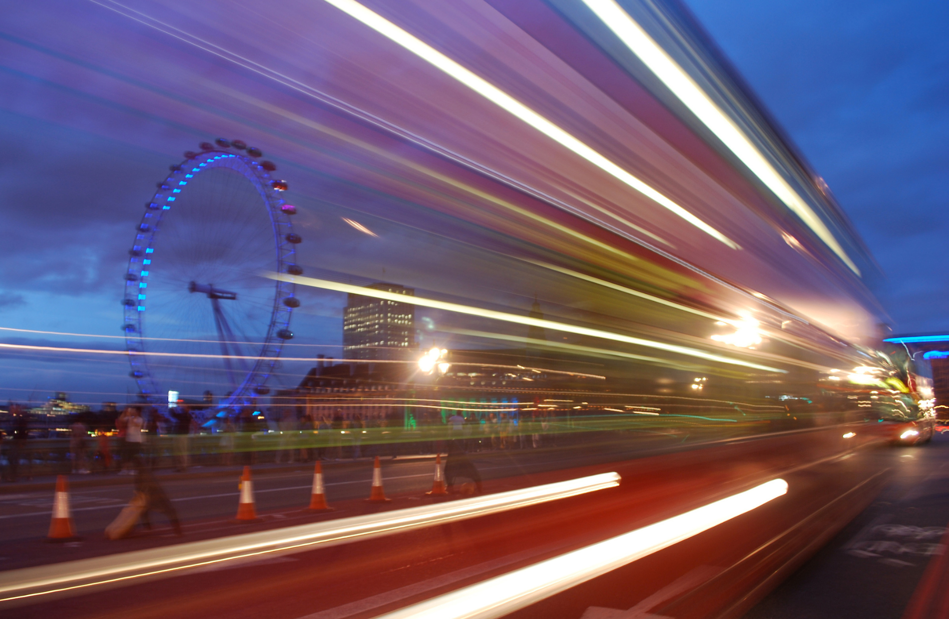 View of the London Eye transposed with a shadow of double decker bus speeding by