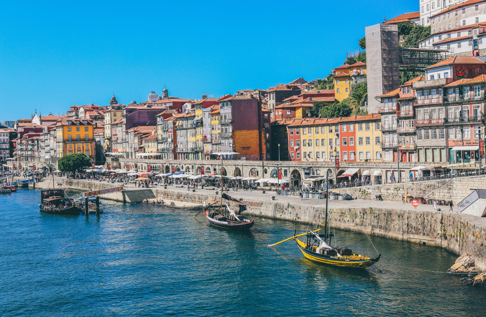 building on a coastline harbor with boats in the water