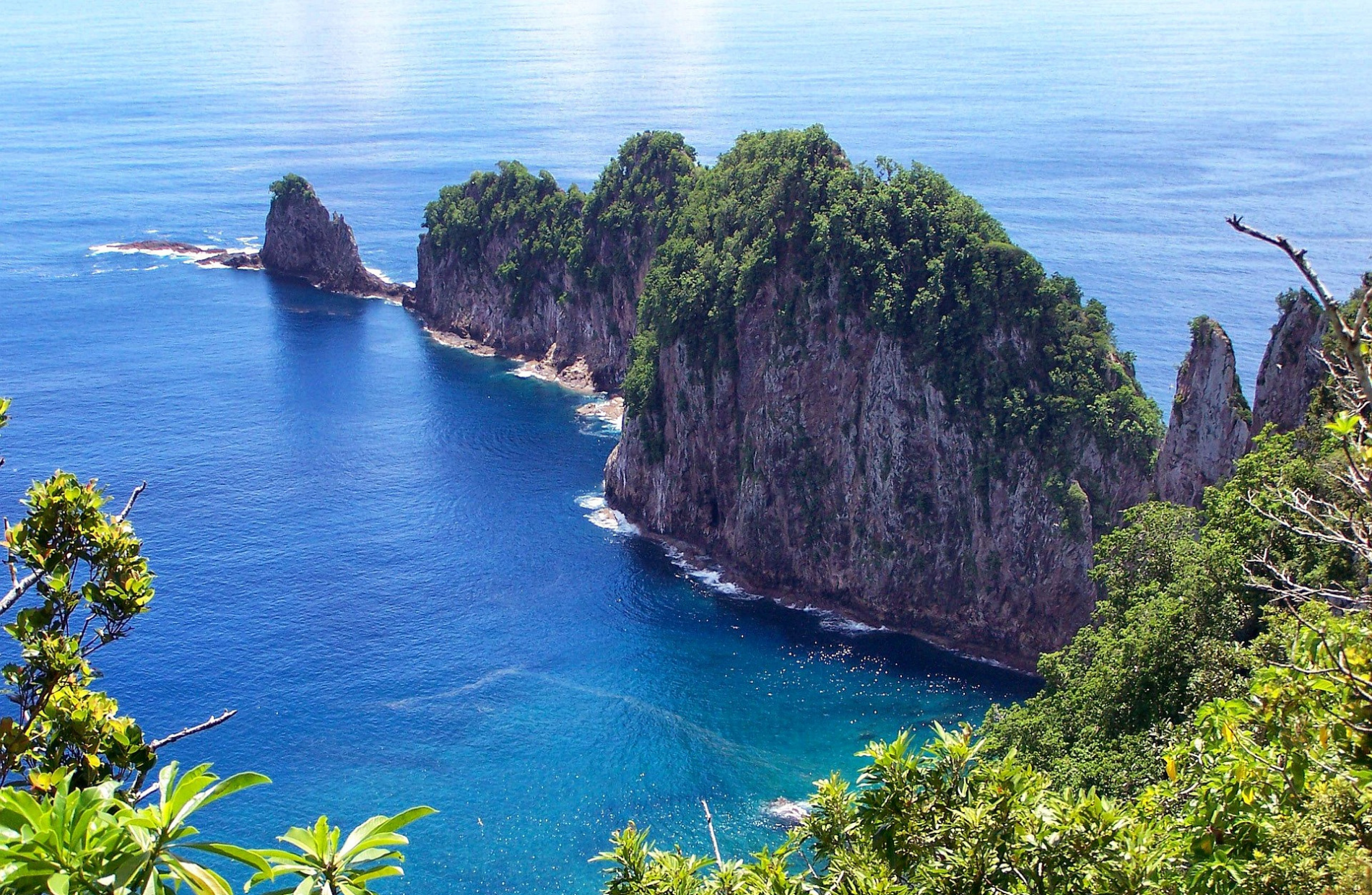 View from a mountain top looking down on tall narrow landmasses jutting out towards the ocean