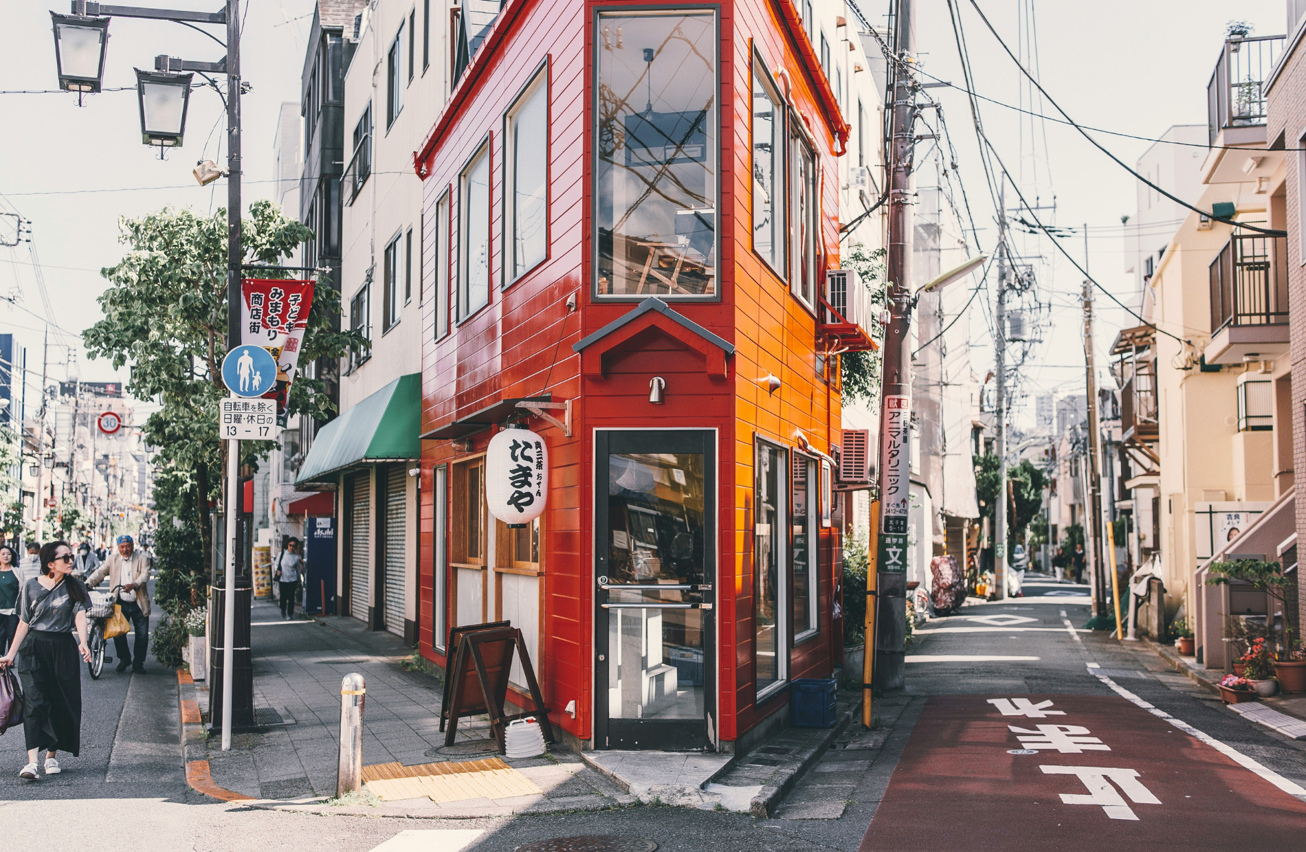 woman standing next to red building