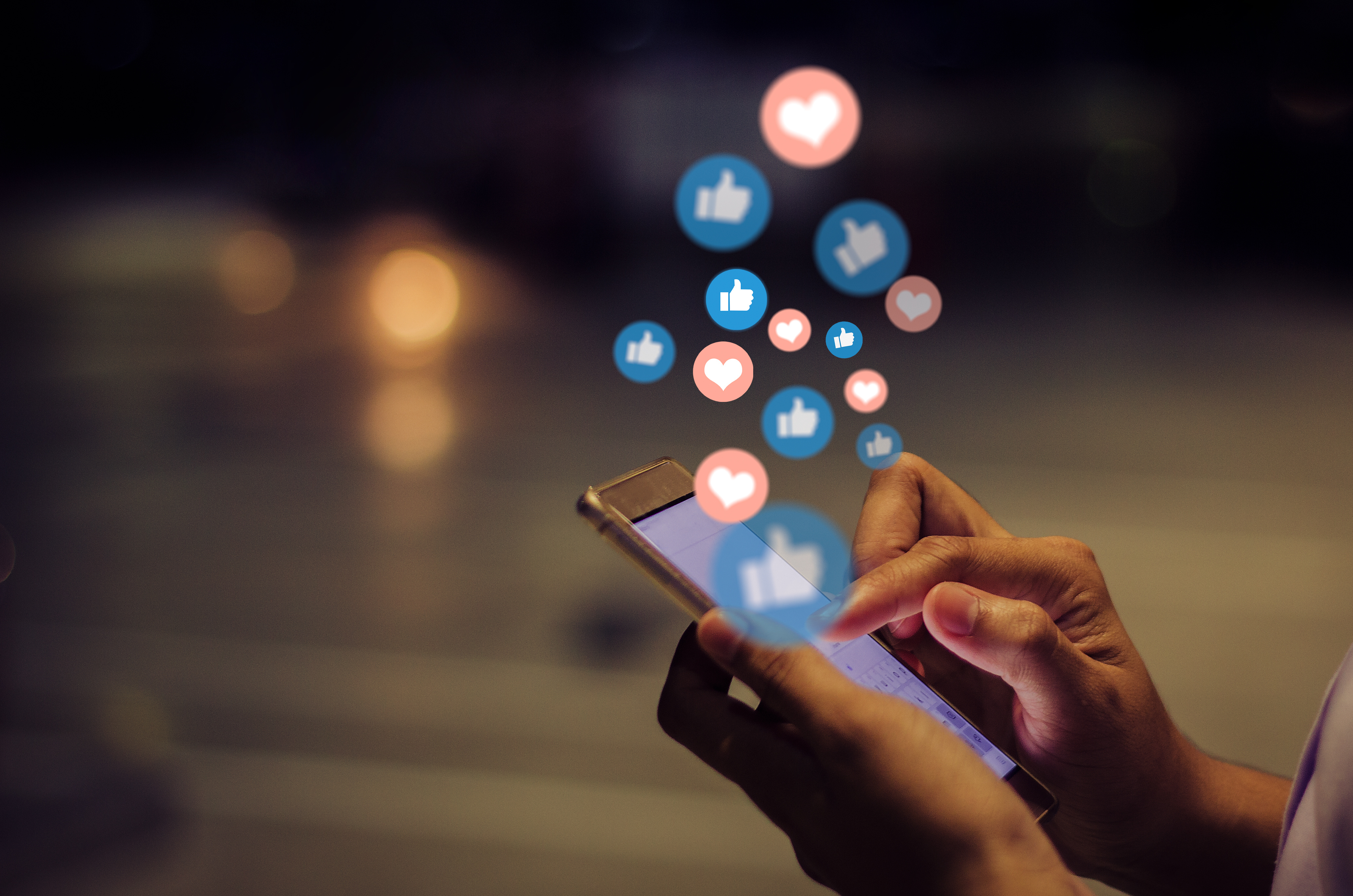 Graphic representing social media engagement through likes and reactions on a smartphone.