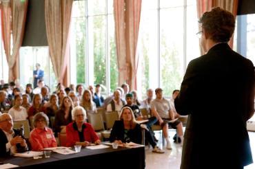 A presenter in front of an audience