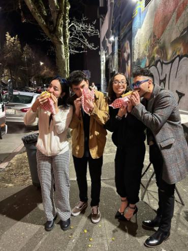 Three diners snacking on hot dogs