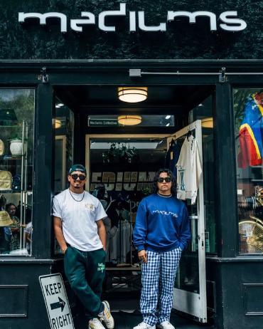 Two men standing outside a store front