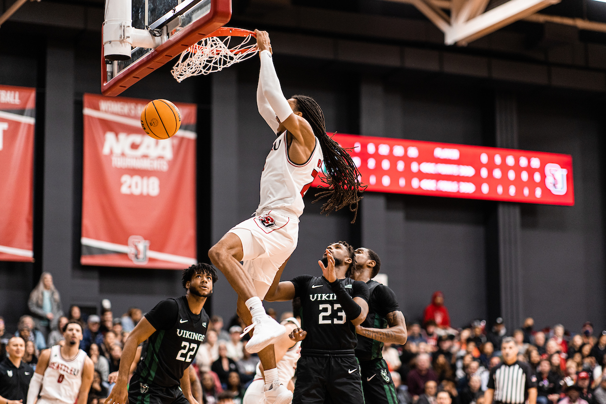 Basketball player dunking bal