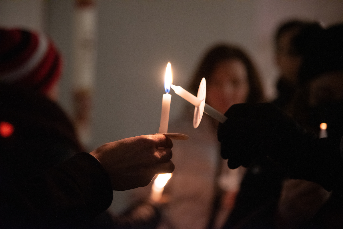 A photo of two candles lighting eachother