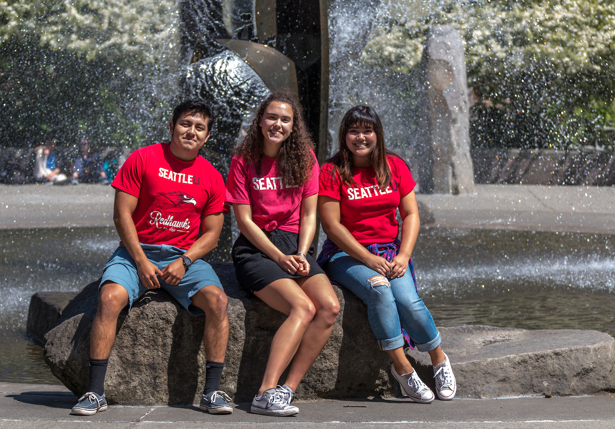 Students sitting in front of fountain