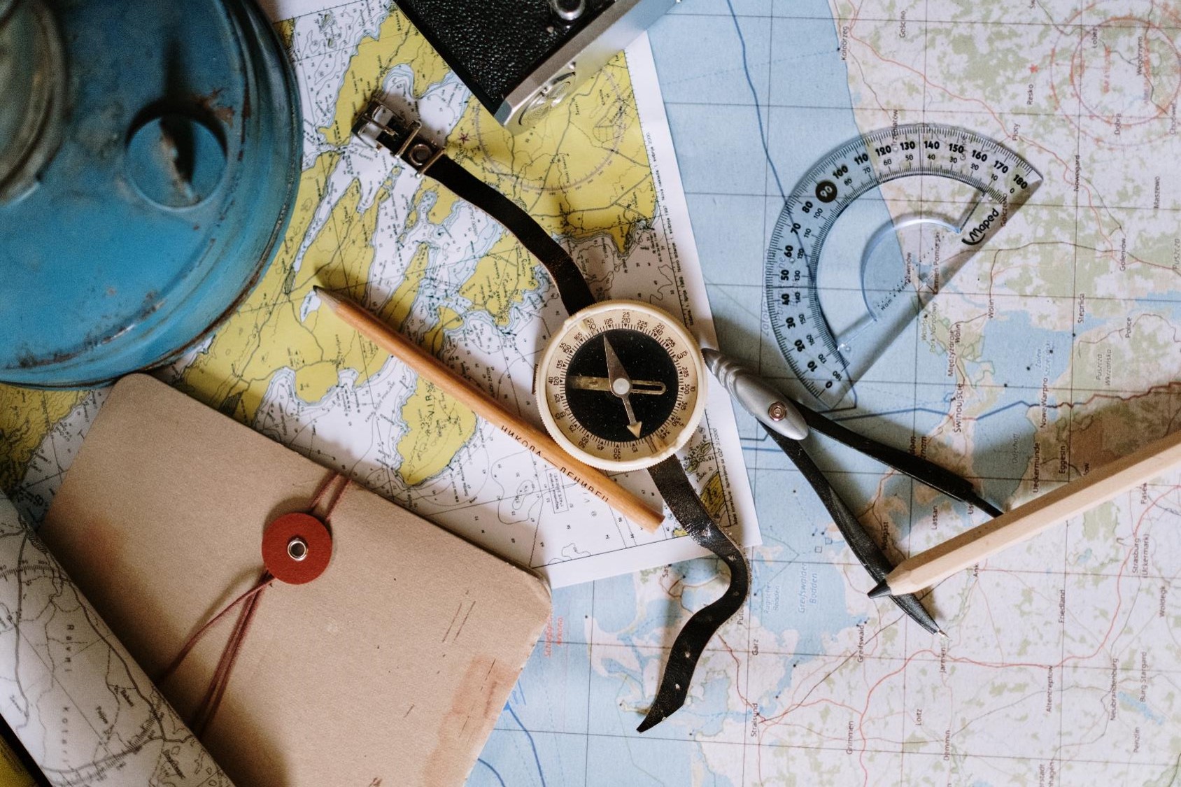 Photo of map, compass, and map-making equipment