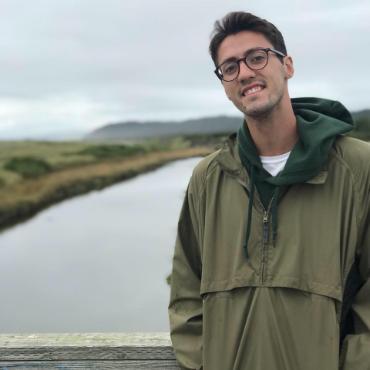 Photo of Nathan Pixler in front of body of water