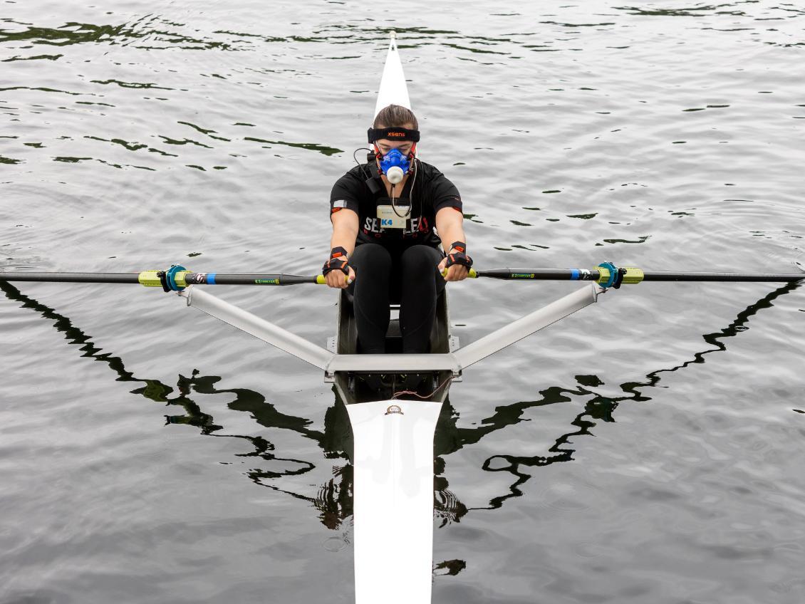 Student rowing wearing measurement gear