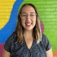 photo of Jennifer Cruz in front of colorful wall