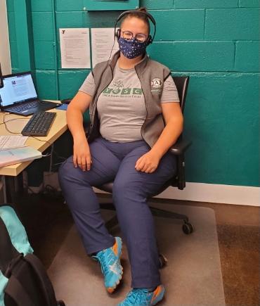 Photo of Jessie Dirks at desk wearing a mask