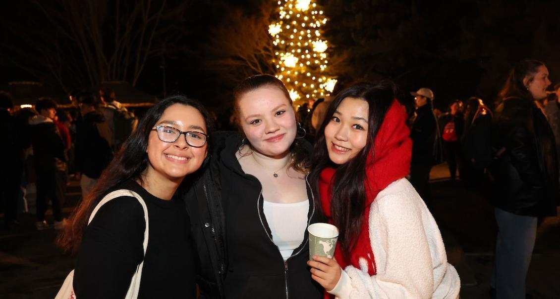 christmas tree lighting trio of girls