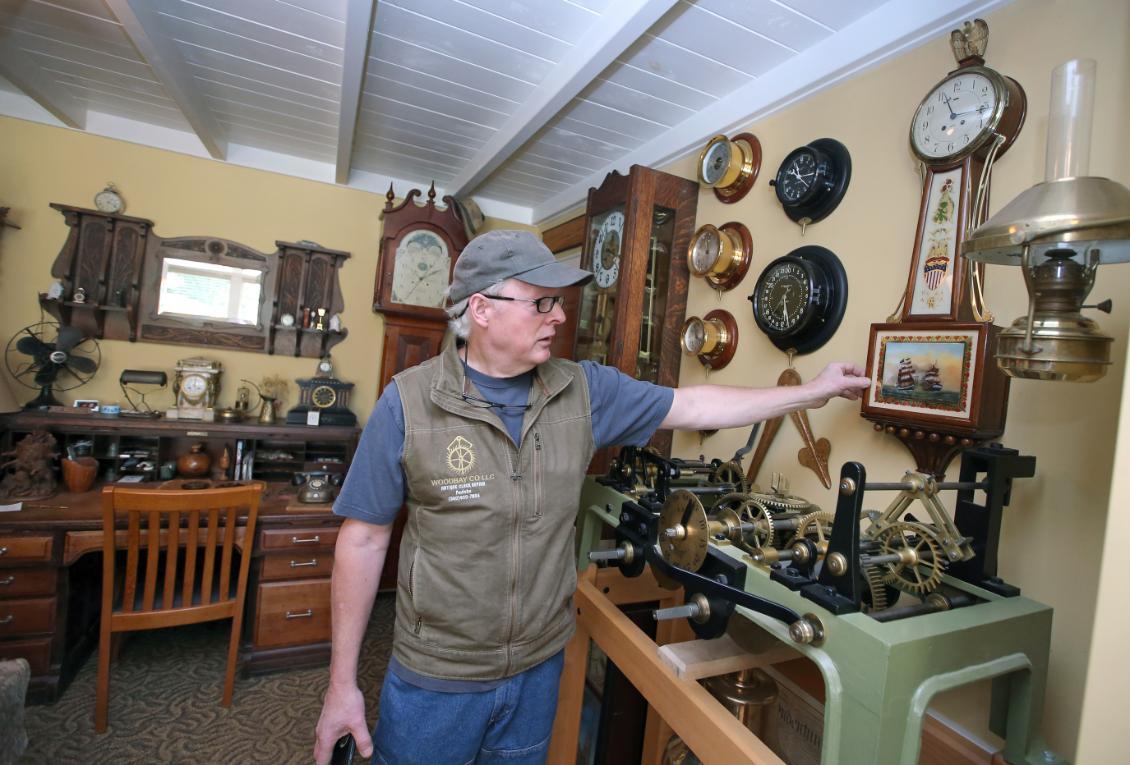 clock maker showing off shop