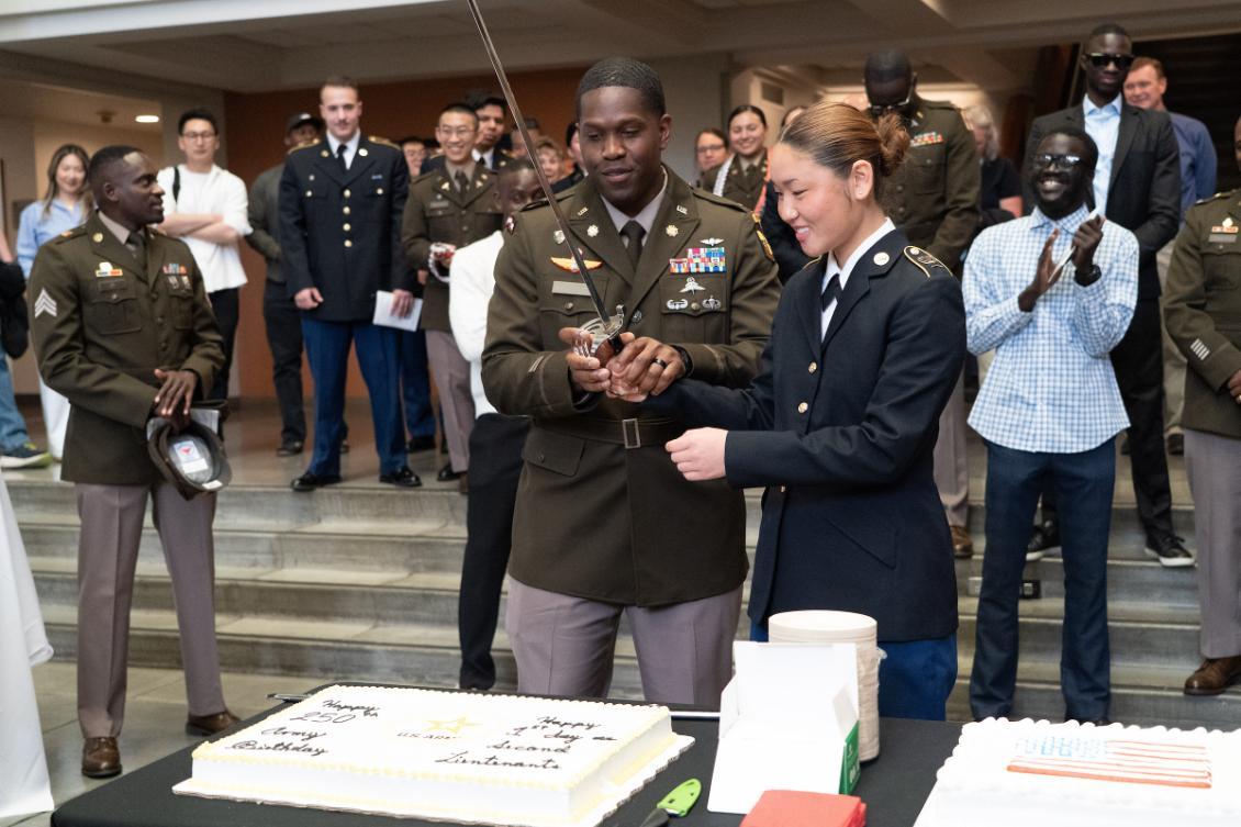 two cadets cutting a cake
