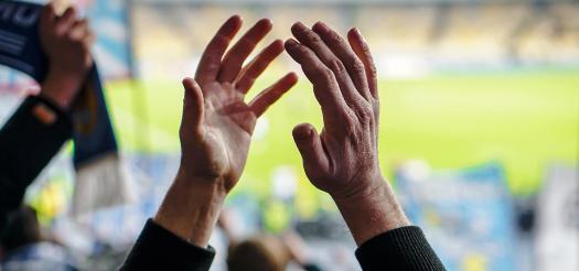 Hands Applauding at a Sports Match