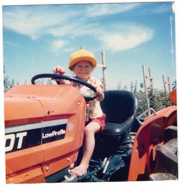 PMBA student Julia Bringolf as a child on the family tractor