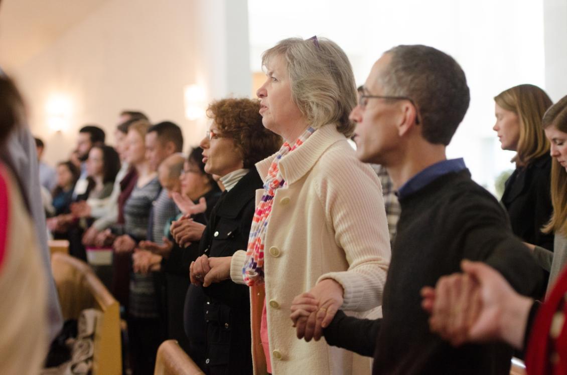 Photo of people praying at mass