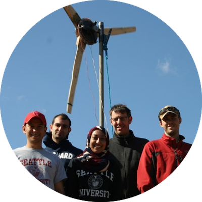photo of a group of SU students in front of a wind turbine