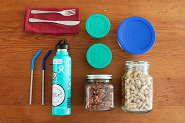 a photo of a reusable straw, napkin, bottle, and jars