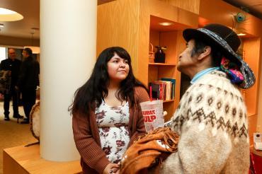 student standing to the left of an elder with a double gulp cup in his hand in the Indigenous Peoples Institute