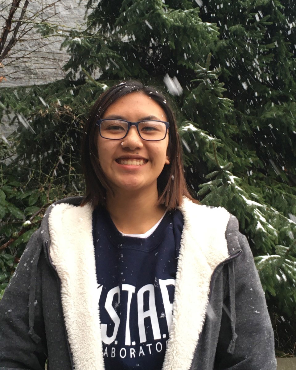 Undergraduate student Erin Camemo standing outside with snow falling 