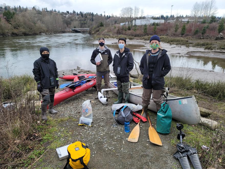 Students with waders on Duwamish River bank