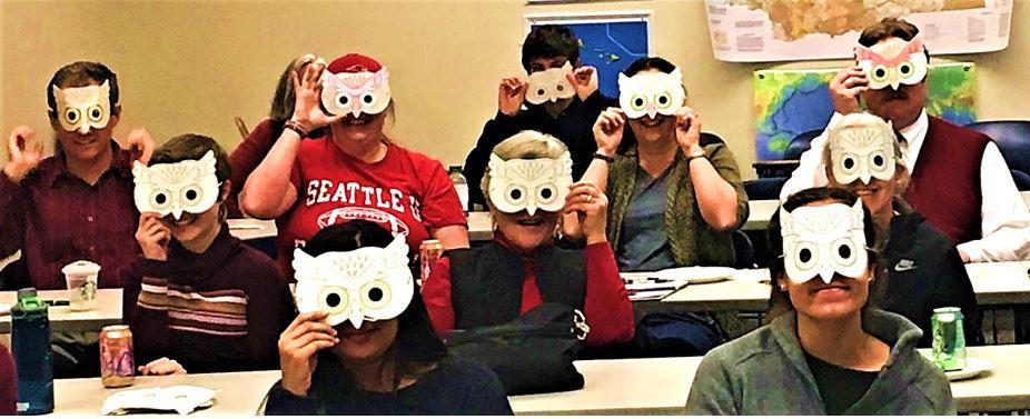 SMART Friday attendees wear owl masks at a talk about owls and computational neuroscience