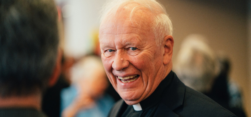 Fr. Pat Howell Smiling in Collar