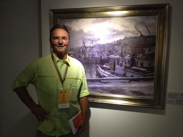 Paul Mullally with a painting of his in London