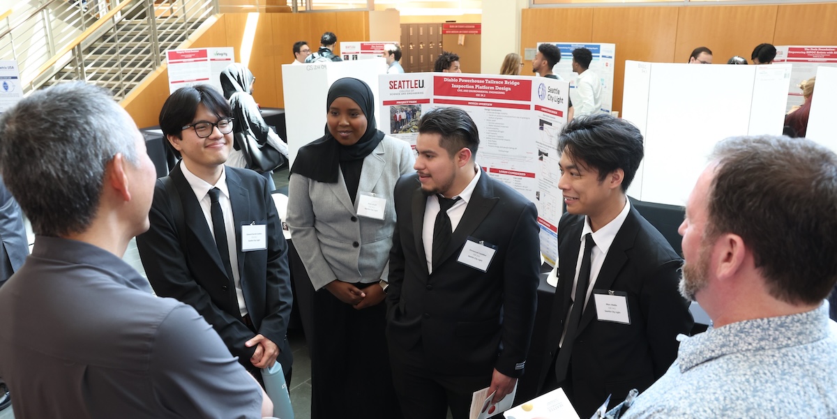 students talk to guests at projects day