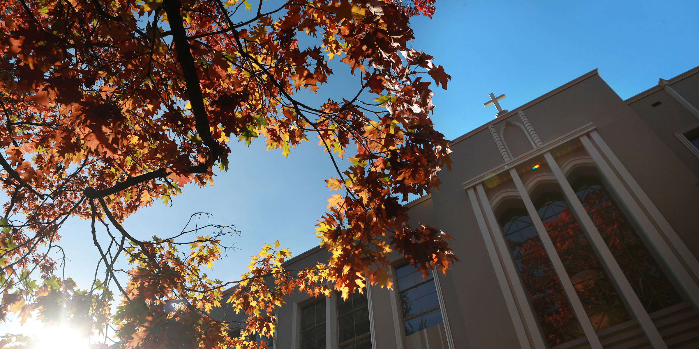 looking upwards at the entrance to the Administration building and colorful fall trees