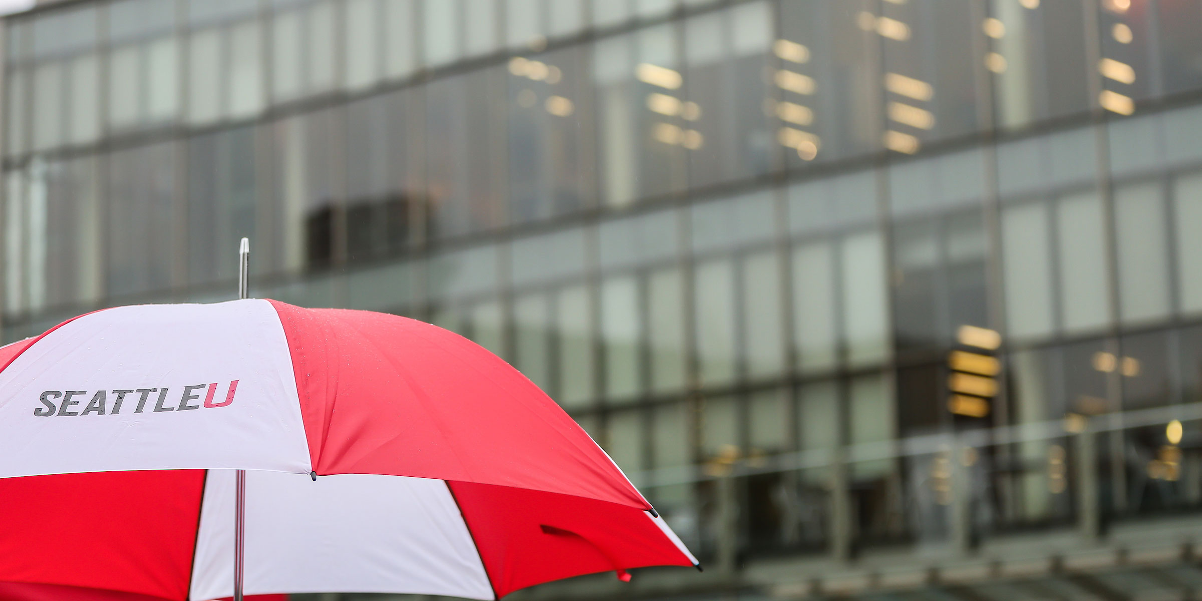 bright red and white SU umbrella on a rainy day
