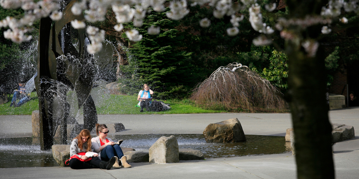 students reading at the fountain in the Quad