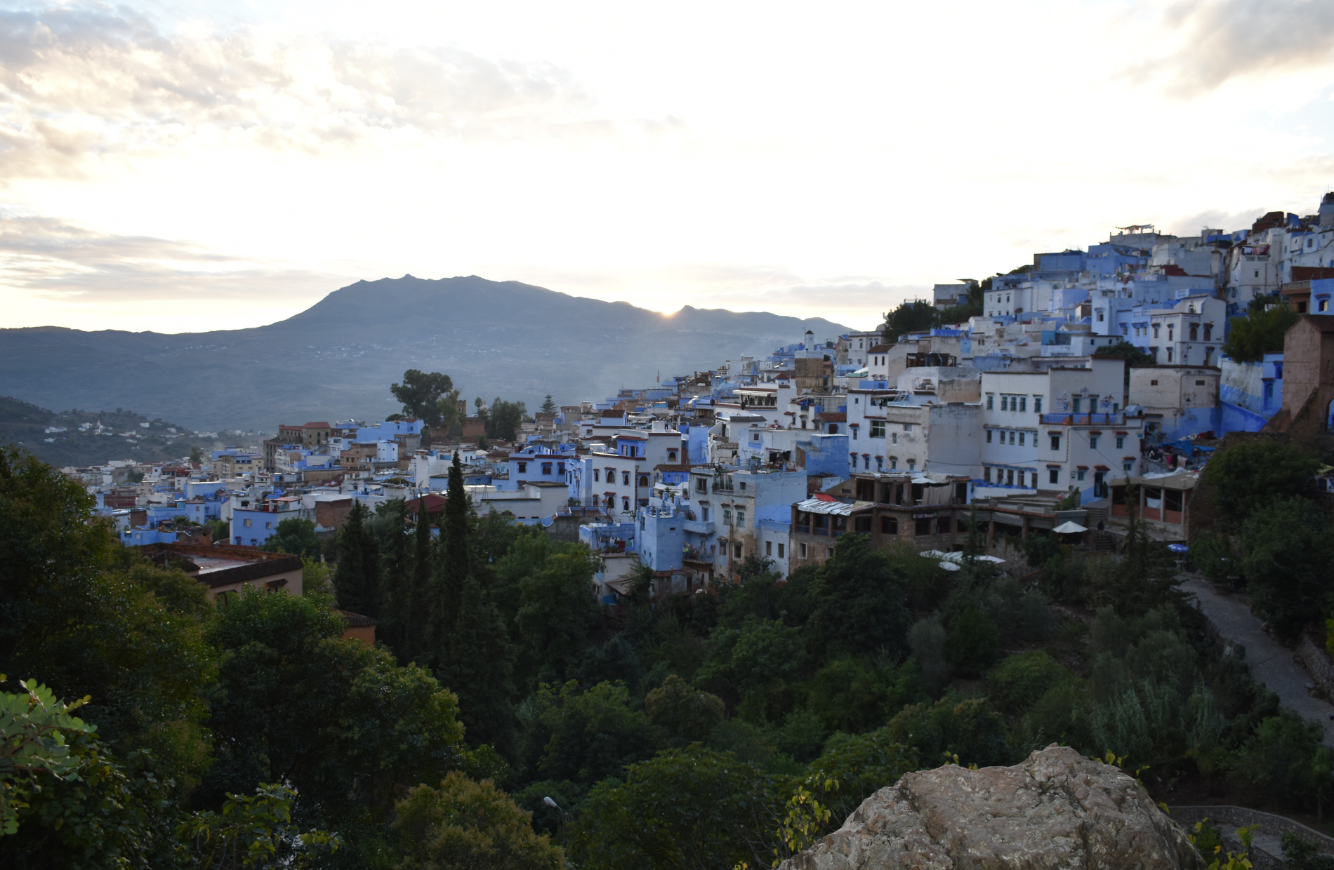 view of the mountainside lined with white and blue buildings