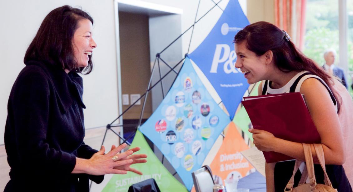 A company representative talking to a student at a career fair