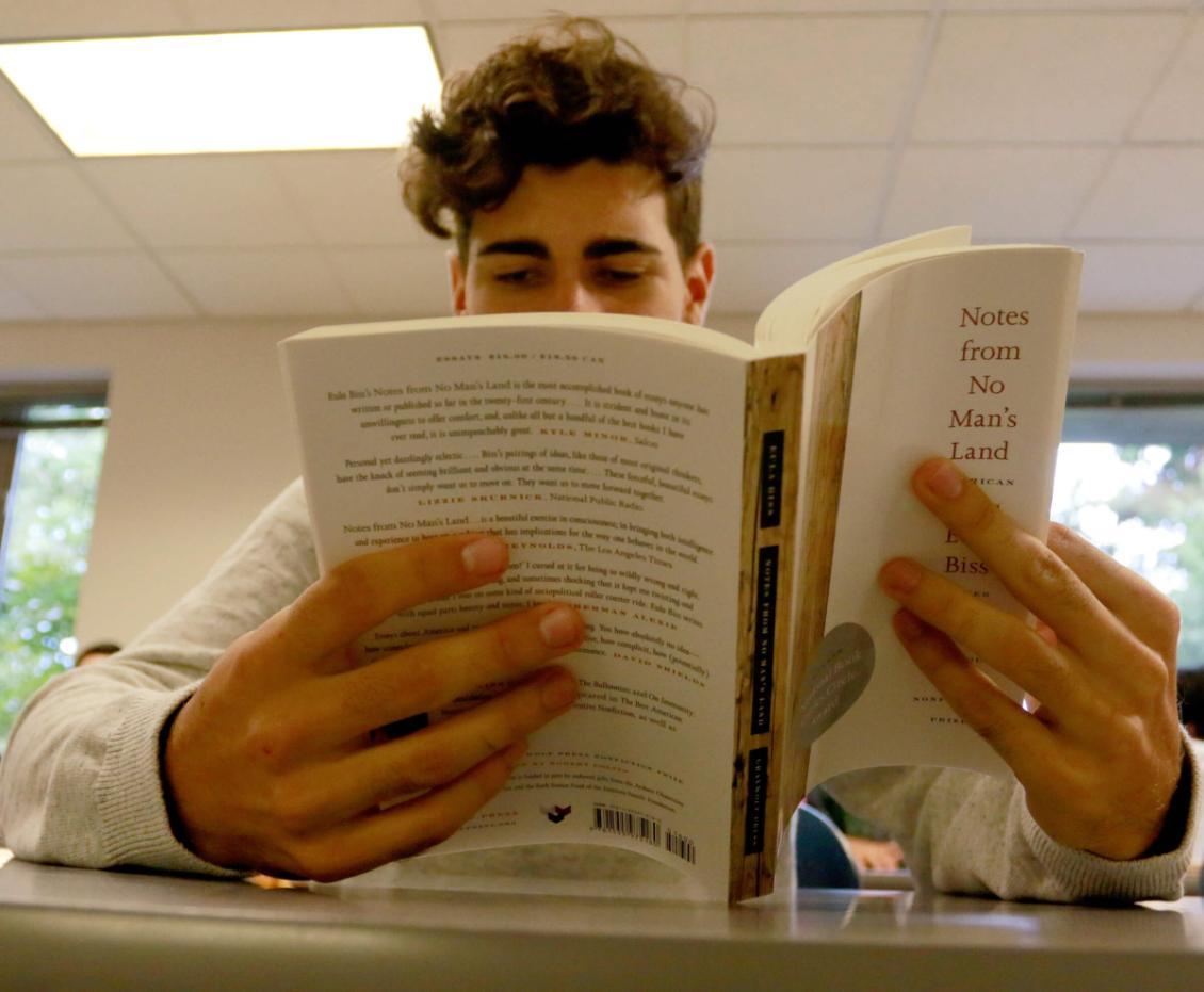 Student reading Notes from No Man's Land by Eula Biss