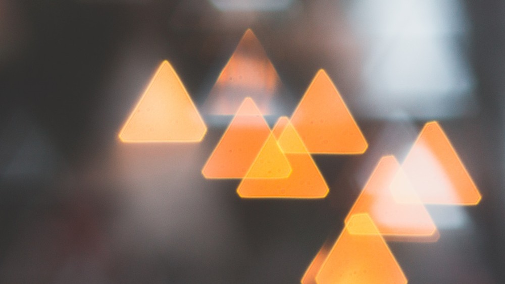 Bokeh image of triangular lights pointing upward