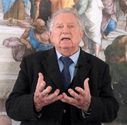 Pat Burke speak in front of mural