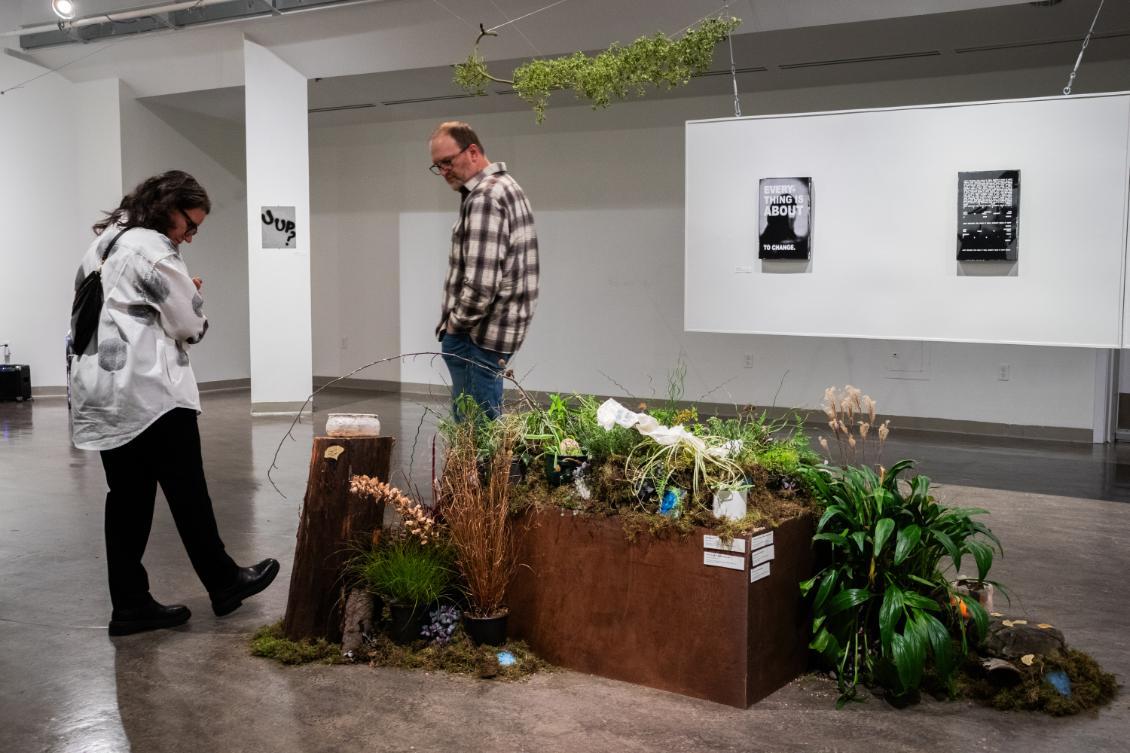 Art work in gallery with people around