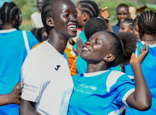 two students playing soccer