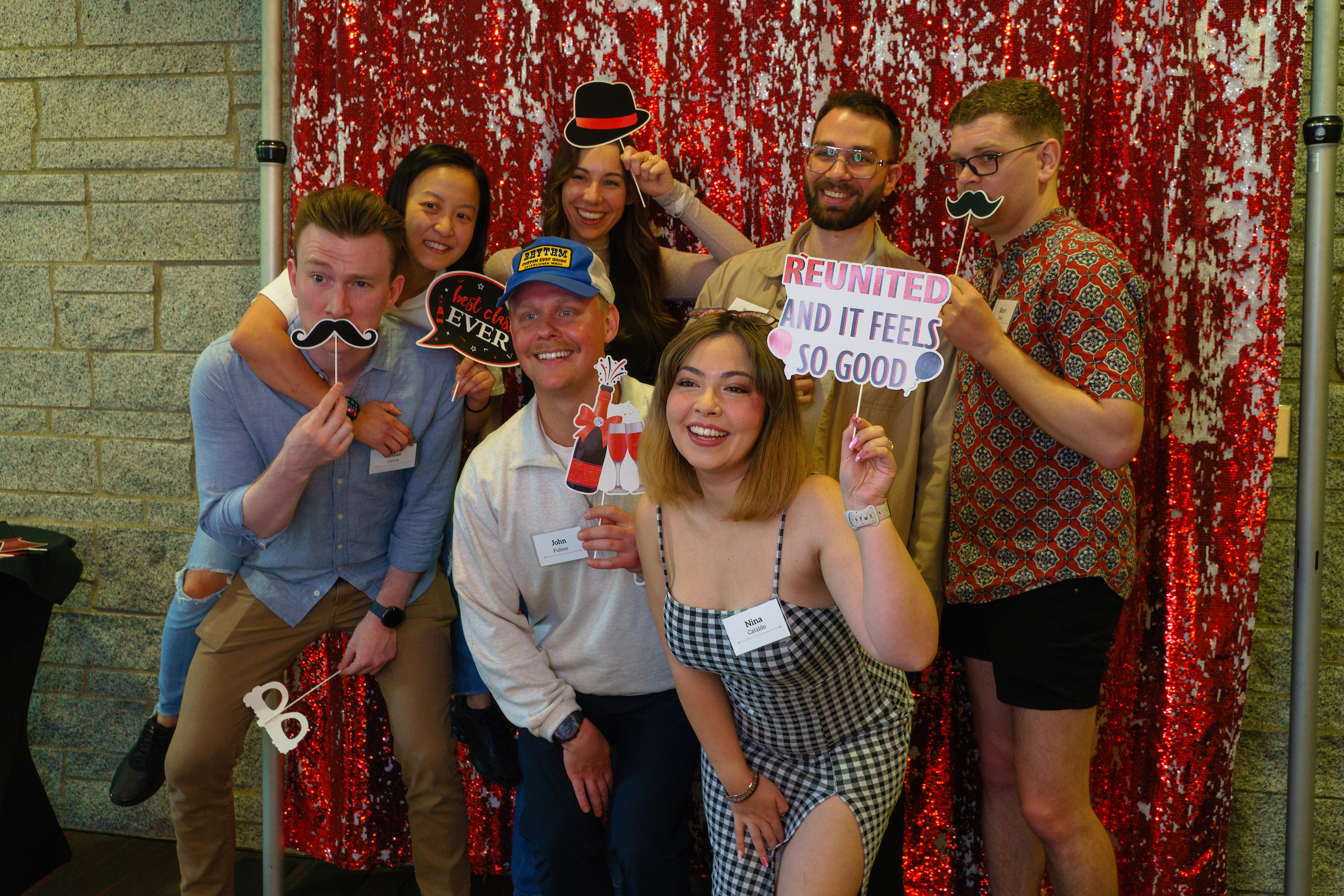 group shot of alumni with costume props at a reunion