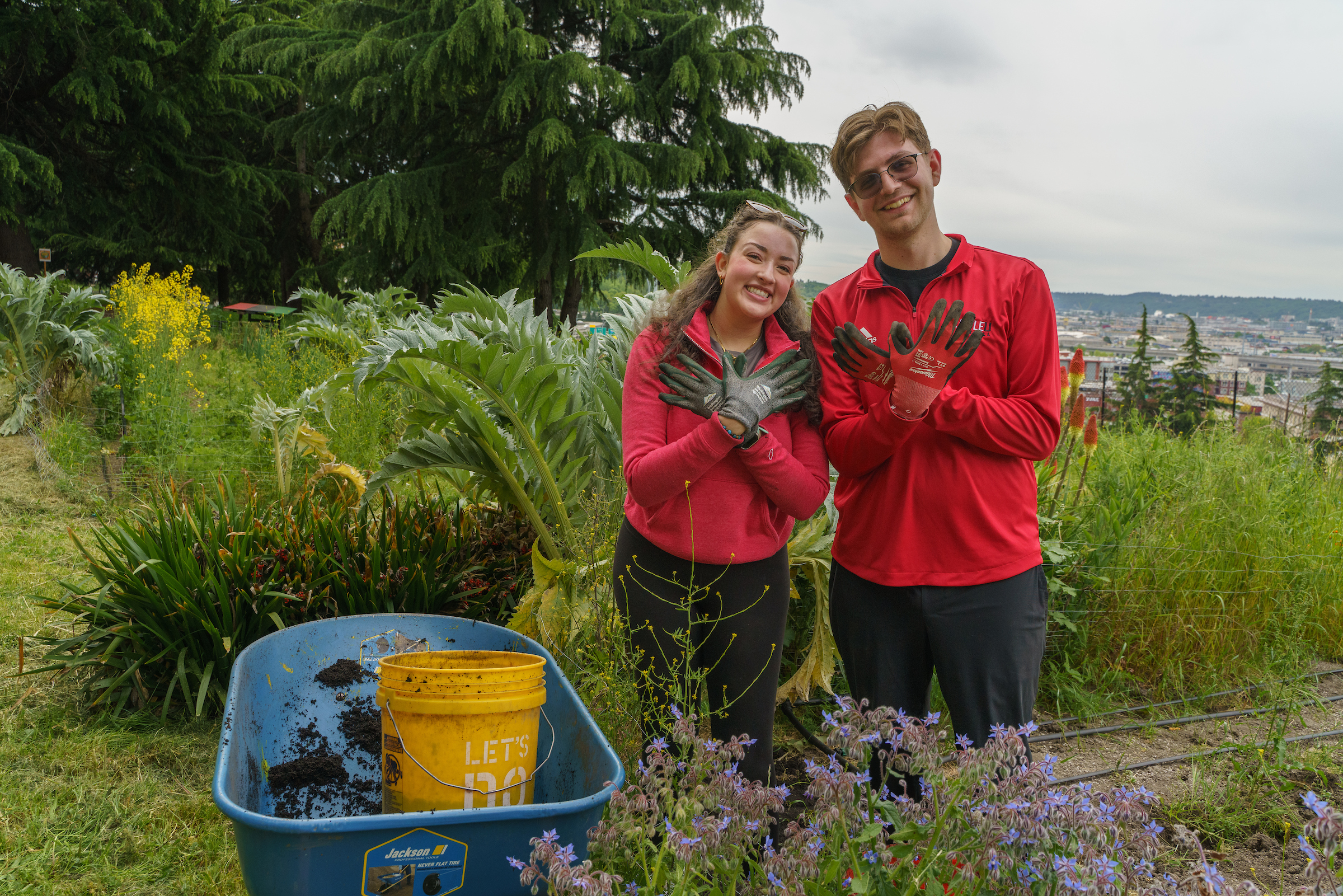 two alum posing with hawk hands in a garden