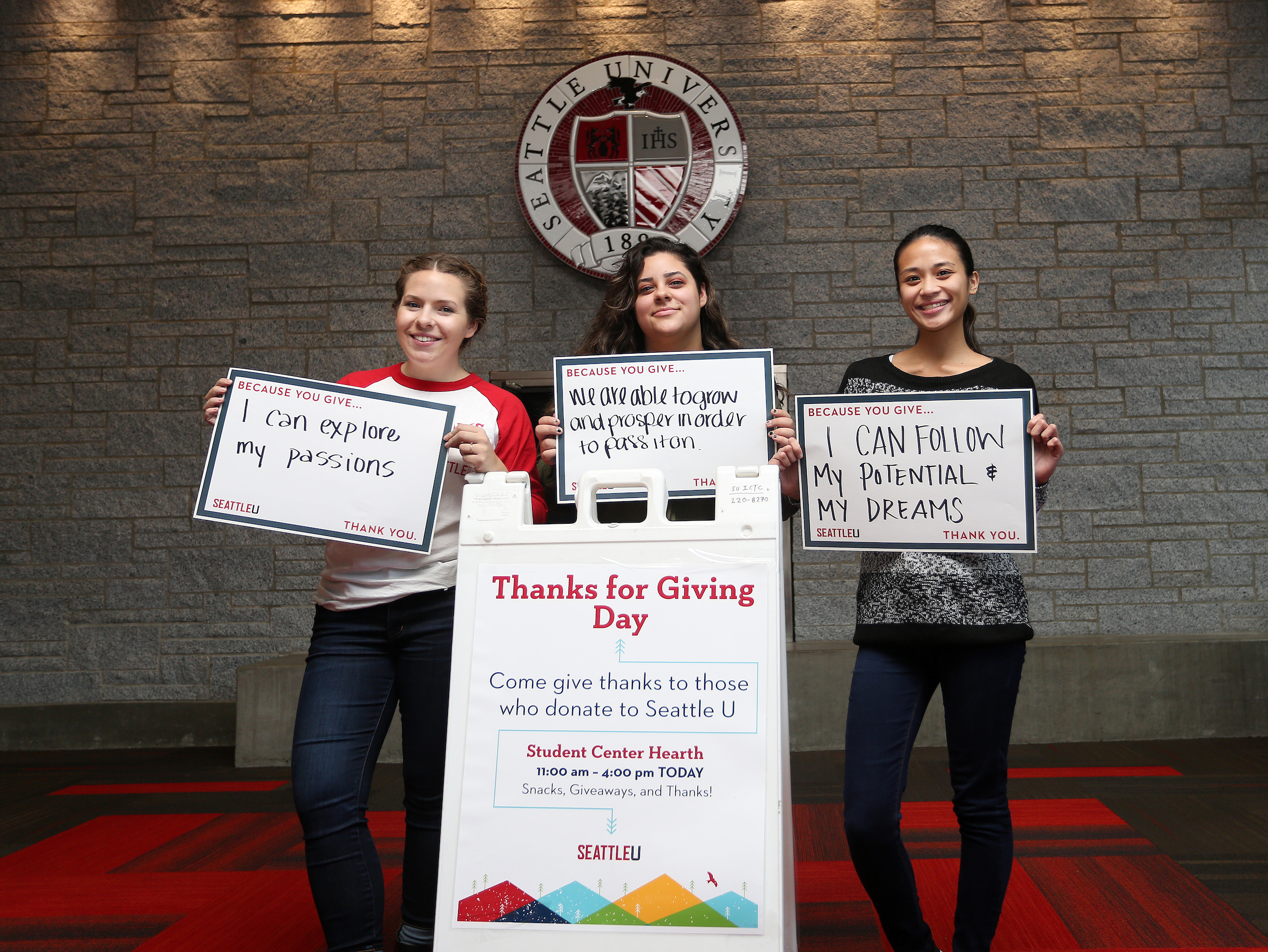 students holding thank you signs