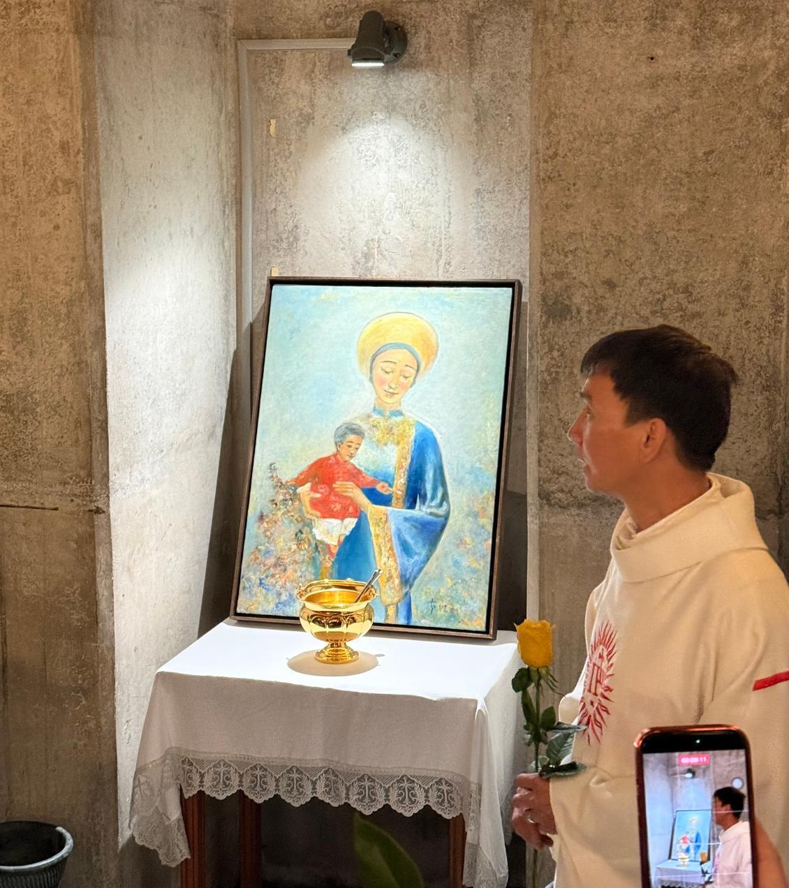 Trung Pham standing with art