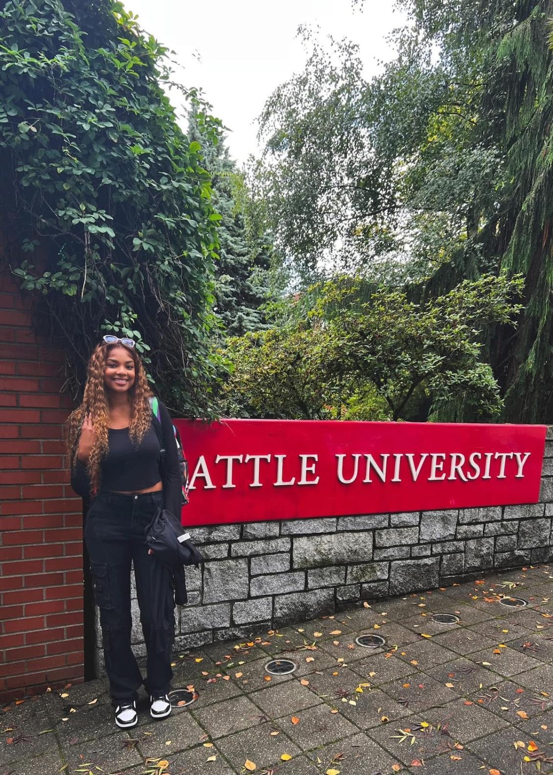Seahawks McClain in front of SU sign