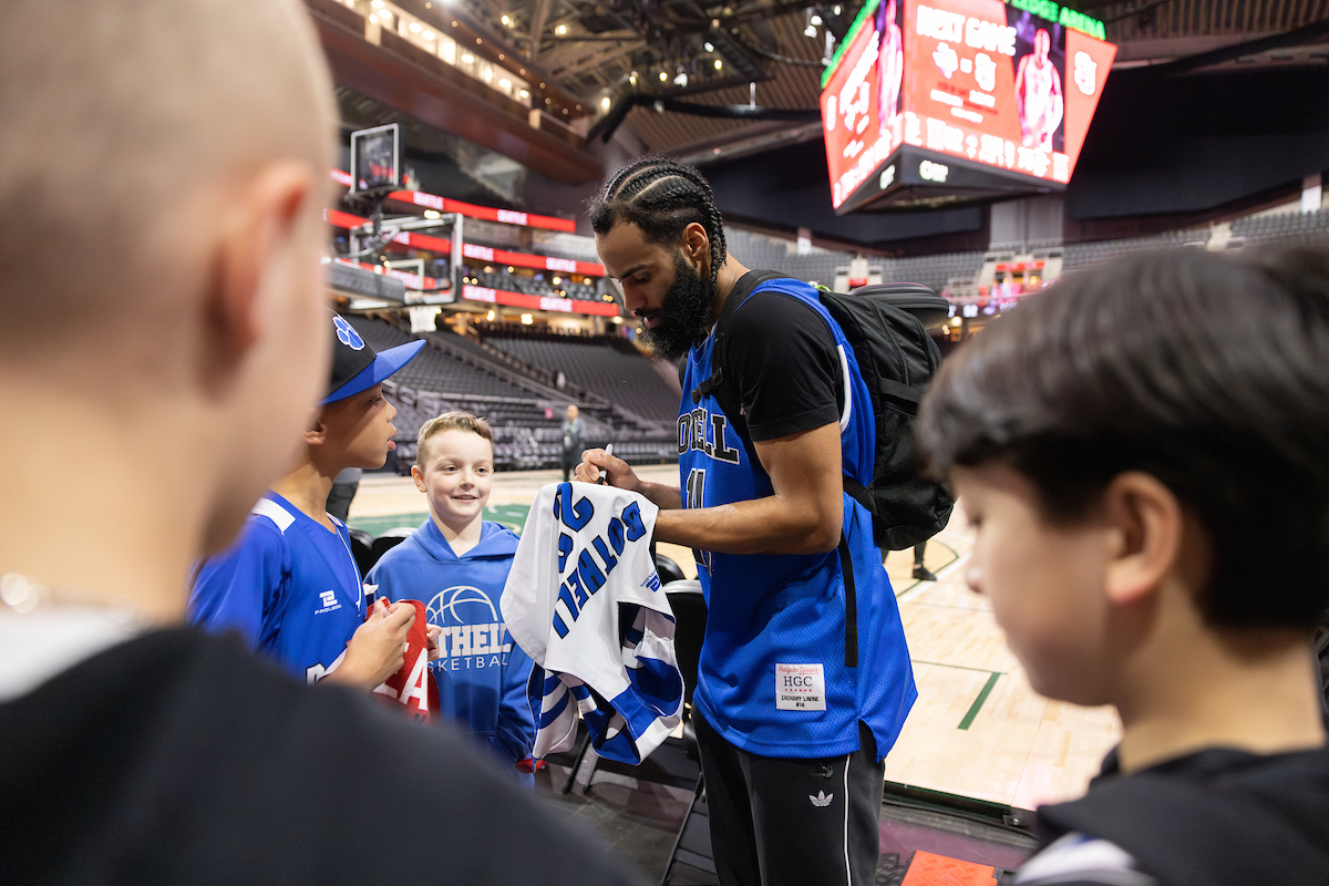 Cameron Tyson signing a jersey at his pre-SU alma mater, Bothell High School.